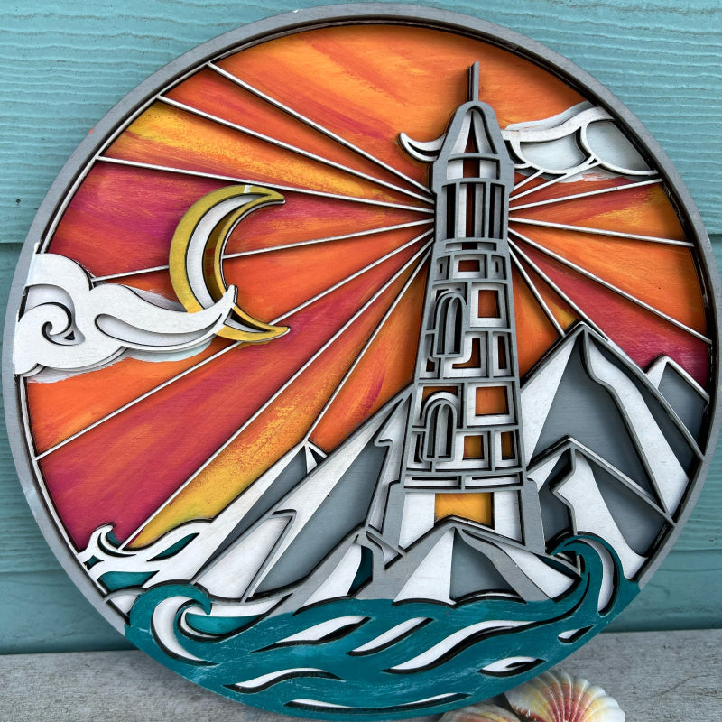A decorative layered round art piece with a lighthouse design, featuring multiple colors and layers, placed against a teal background.
