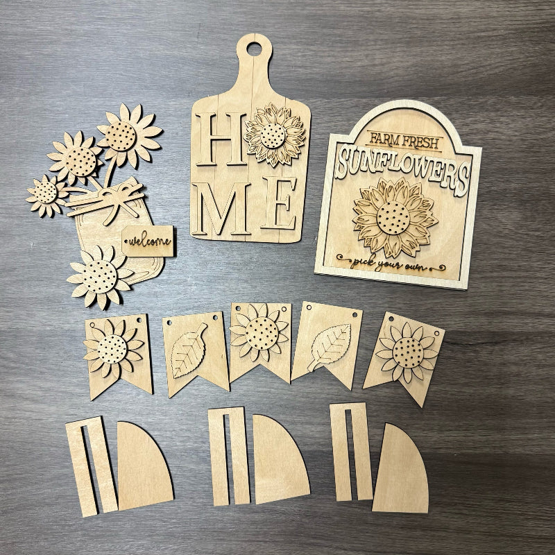 Set of wooden cutouts with sunflower designs on a wooden surface