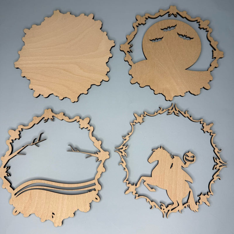 Four wooden cutouts with decorative patterns on a gray background