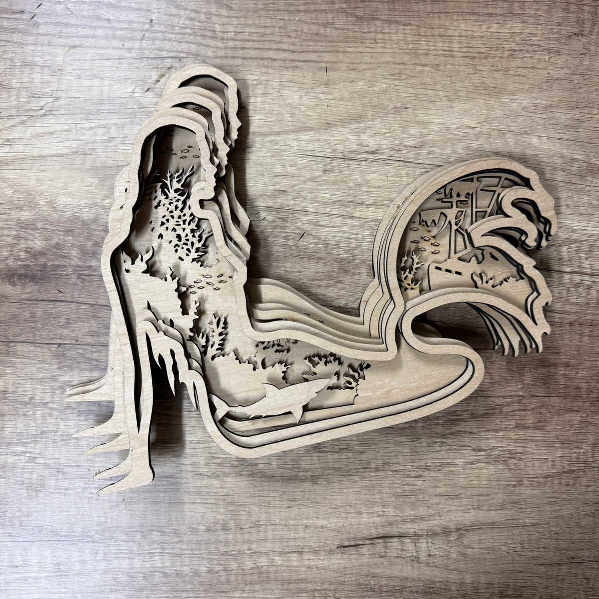 Wooden laser-cut decorative piece on a wooden surface