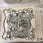 Wooden cutout of a design with floral elements on a wooden surface