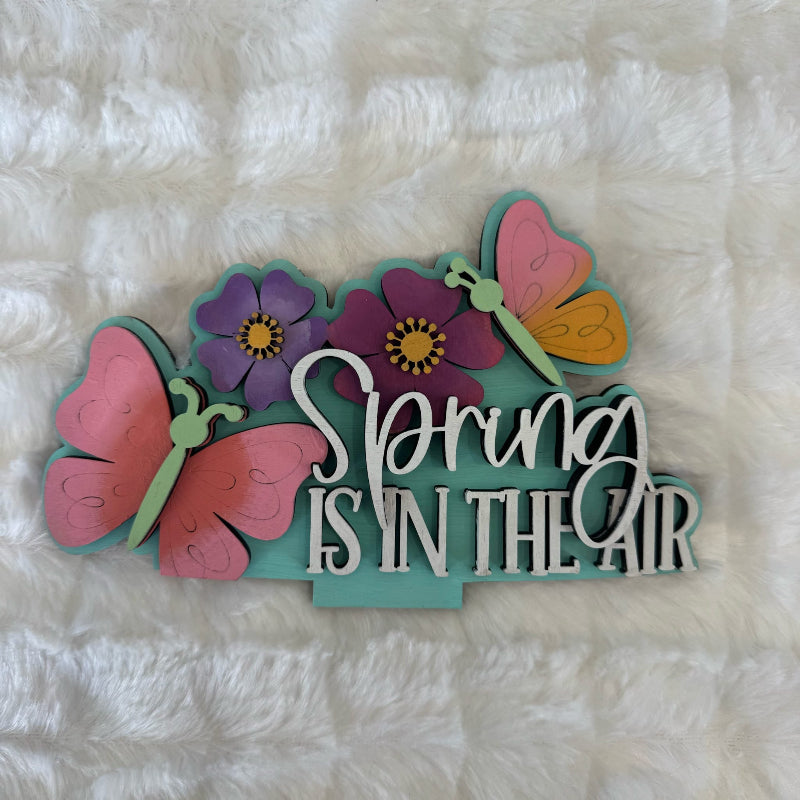 Decorative sign with flowers and butterflies on a textured white background