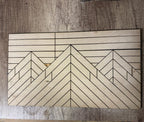 Wooden cutting board with geometric pattern on a wooden surface