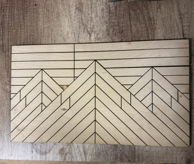 Wooden cutting board with geometric pattern on a wooden surface