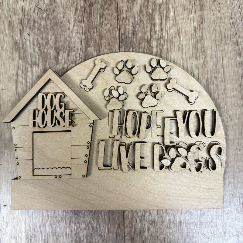 Wooden decorative sign with doghouse design and text on a wooden surface