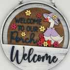 Decorative sign with a goose illustration and 'Welcome to our Porch' text on a wooden background.