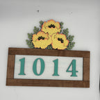 House number sign with flowers on a white background