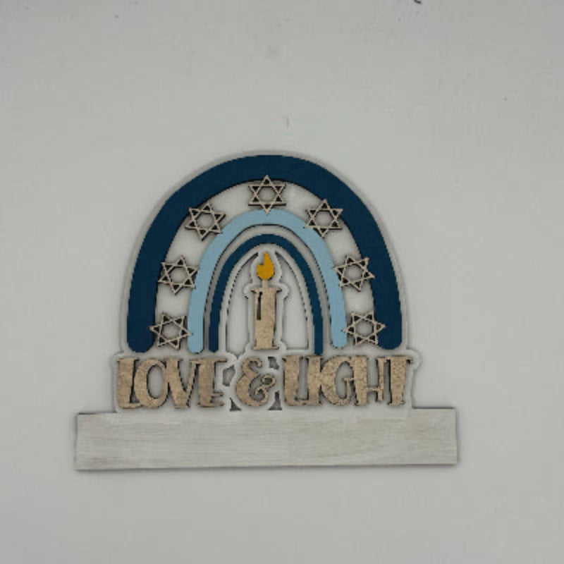 Decorative wall art with arch, candles, and 'Love & Light' text on a white background