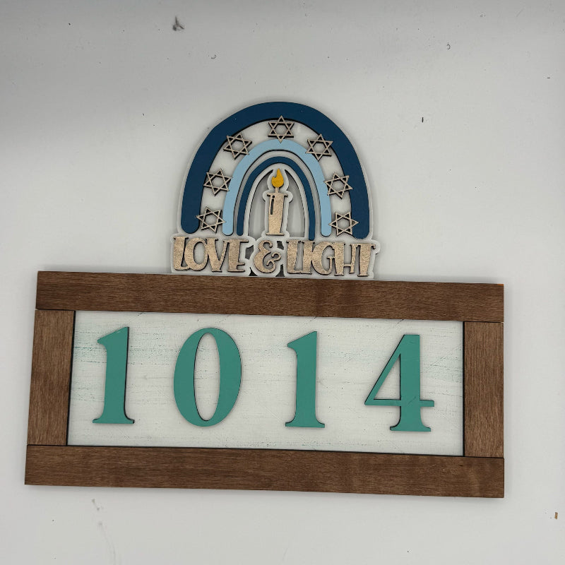 Decorative house number sign with 'Love & Light' and number '1014' on a white background