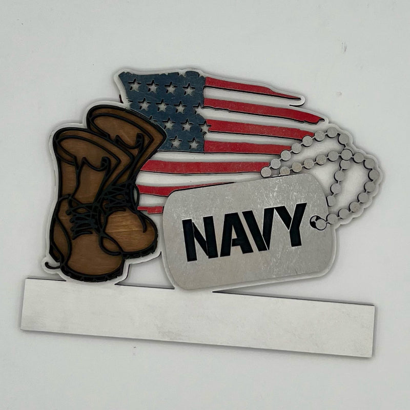 Decorative item with American flag, boots, and 'Navy' dog tag on a white background