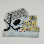 Decorative sign with hockey equipment and text 'We're Probably at the Rink' on a white background