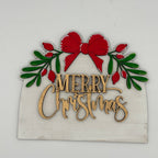 Decorative Christmas sign with red bow, green leaves, and 'Merry Christmas' text on a white background.