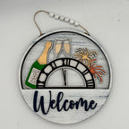 Decorative sign with New Year's Eve elements including a bottle, glasses, and fireworks on a white background.