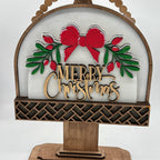 Decorative Christmas sign with 'Merry Christmas' text and bow design on a white background