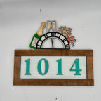 Decorative house number sign with '1014' on a white background