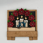 Decorative wall art with poinsettias, candles, and 'JOY' text on a wooden base.