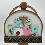 Decorative display with 'Nurse' and 'Love' elements on a wooden stand.