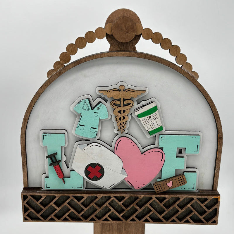 Decorative display with 'Nurse' and 'Love' elements on a wooden stand.