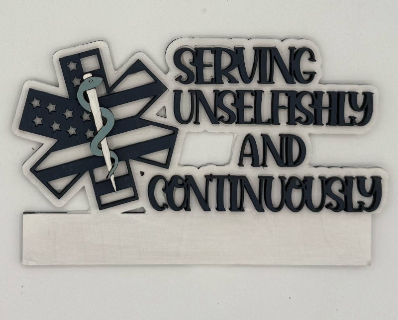 Decorative sign with caduceus, American flag, and text 'Serving Unselfishly and Continuously' on a white background.