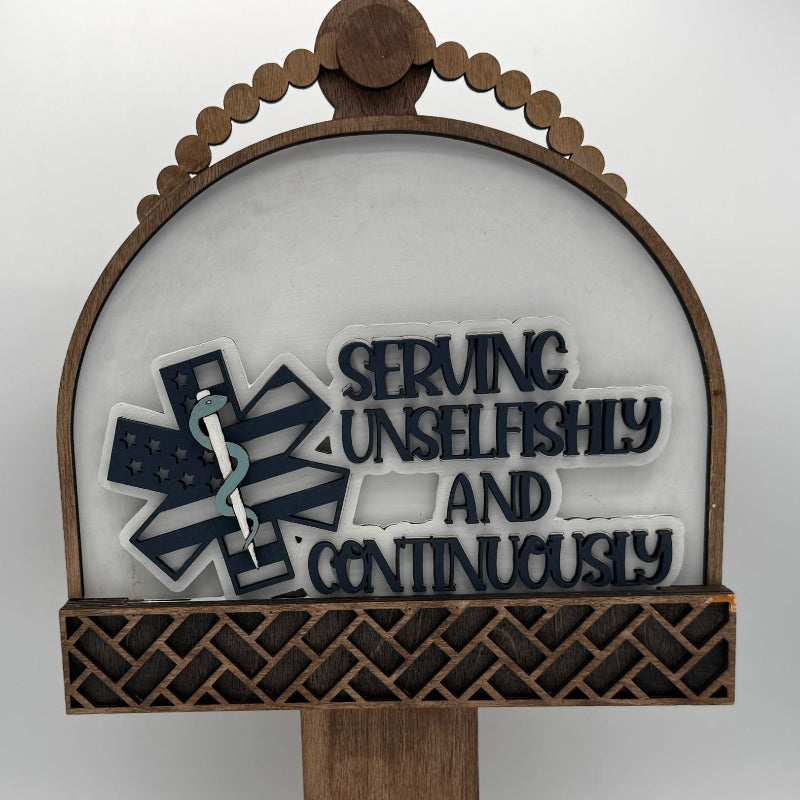 Decorative sign with 'Serving Unselfishly and Continuously' text and emblem on a white background