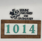 Decorative sign with medical symbol, text 'Serving Unselfishly and Continuously' and numbers '1014' on a white background.