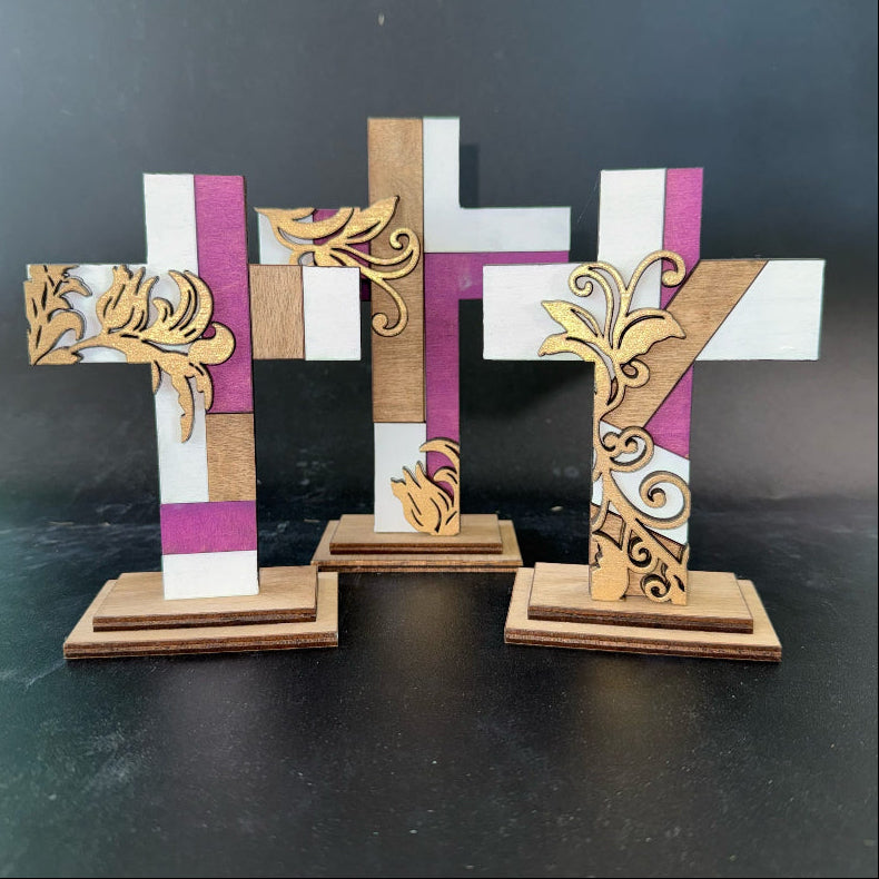Decorative wooden crosses with intricate designs on a dark background