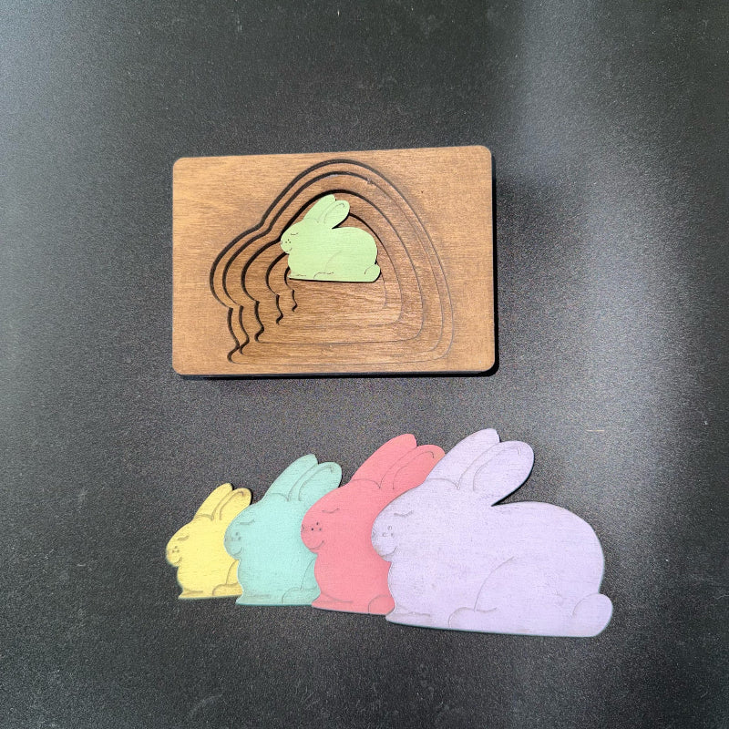 Wooden stamp with cut-out bunny shapes on a dark background