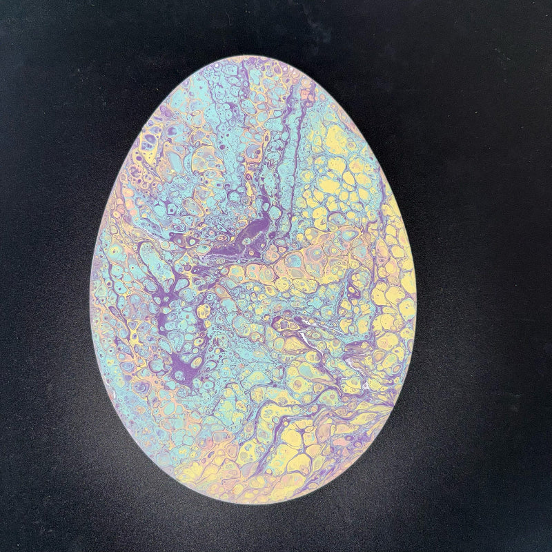 Oval-shaped object with multicolored marbled pattern on a black background