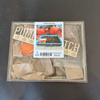 Pumpkin planting kit with decorative signs and packaging on a dark surface