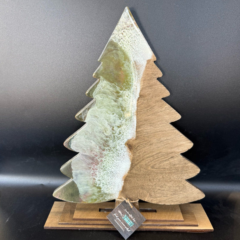 Decorative Christmas tree sculpture with a textured surface on a dark background