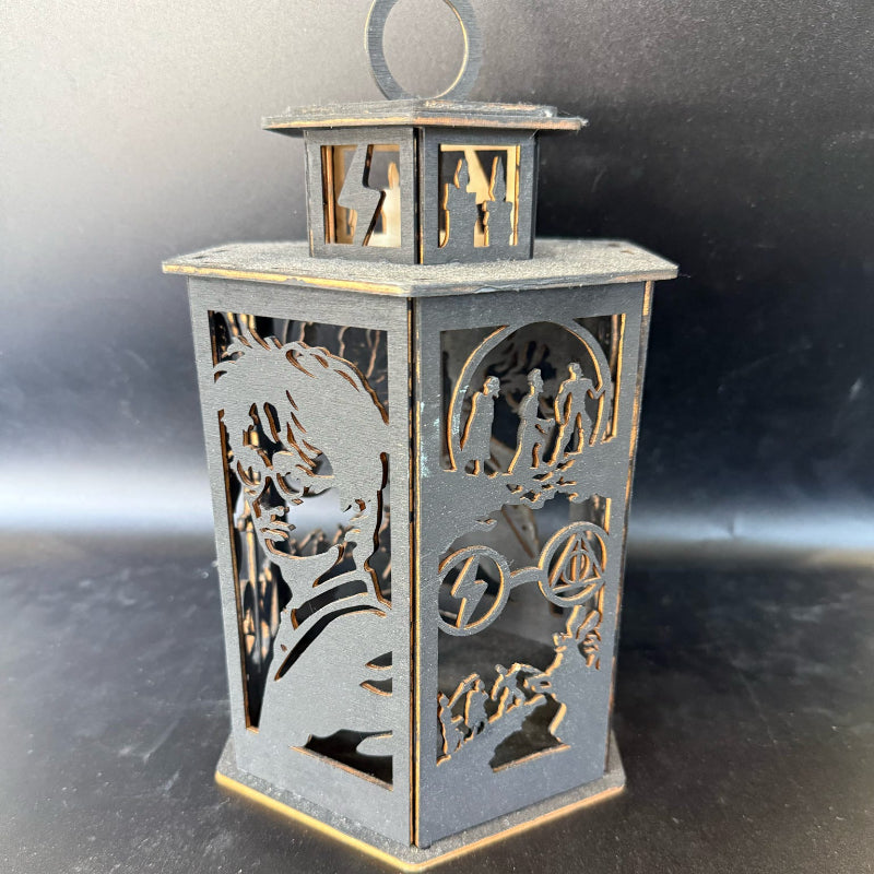 Decorative metal lantern with cut-out designs on a reflective surface