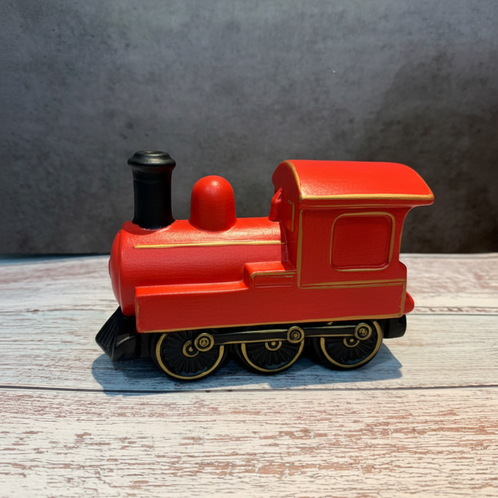 Unpainted ceramic train model on a wooden surface with a gray background