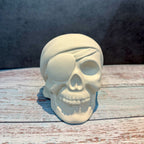Skull-shaped object with a bandage on a wooden surface