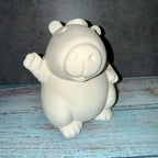 White ceramic bear figurine on a textured blue surface with a gray background