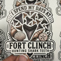 Sticker with 'I Spend My Days at Fort Clinch Hunting Shark Teeth' text and shark tooth design.