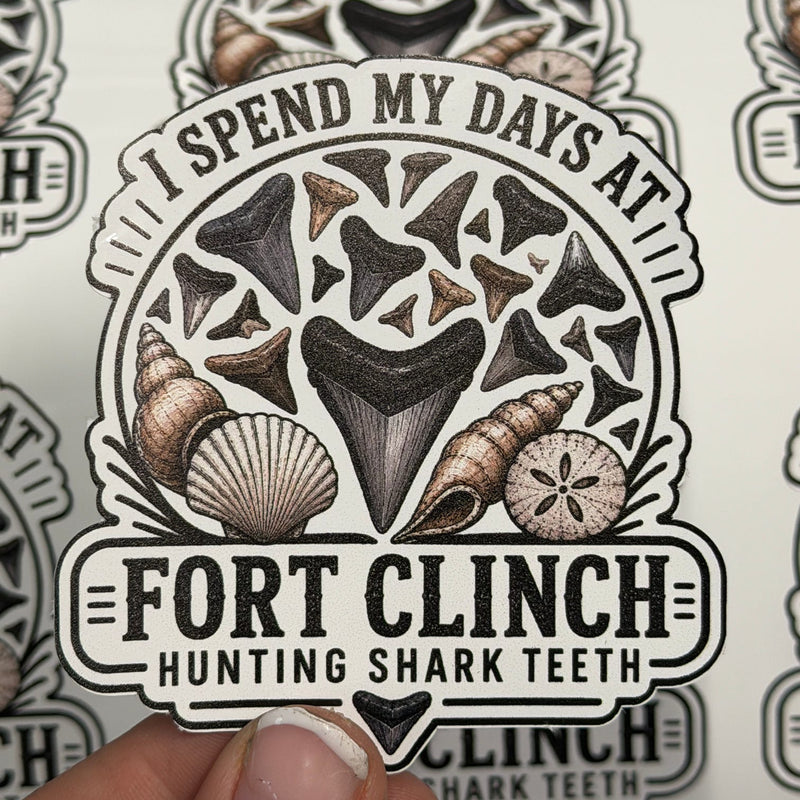 Sticker with 'I Spend My Days at Fort Clinch Hunting Shark Teeth' text and shark tooth design.