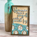 A wooden plaque with a laser cut design featuring a seagull and French fries, with a blue background and text.