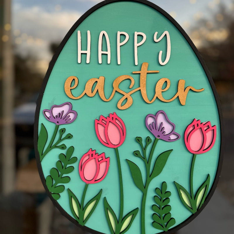 A layered egg-shaped door hanger with the text 'HAPPY easter' and floral patterns in vibrant colors.