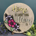 3D layered wooden wall art with the text 'Home is Where your Mom Is' and floral designs