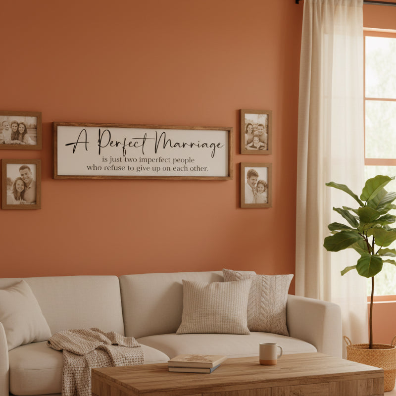 Wooden sign with text 'A Perfect Marriage is just two imperfect people who refuse to give up on each other.' outdoors.