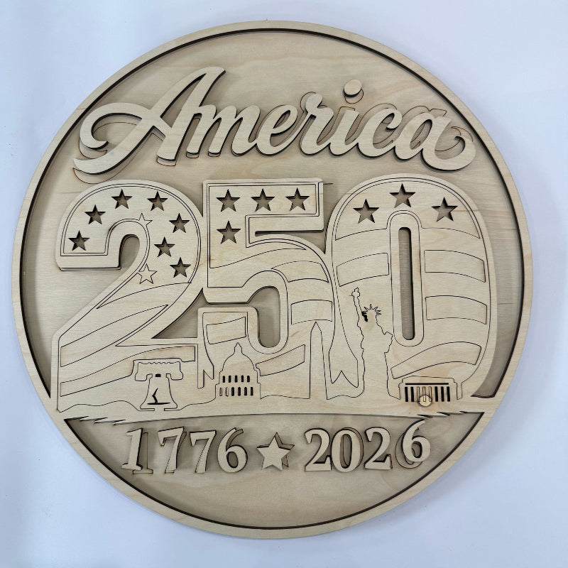 Bronze coin commemorating America's 250th anniversary with symbols and text on a white background