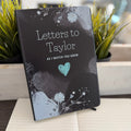 Book titled 'Letters to Baby As I Watch You Grow' with decorative cover on a surface. Perfect for a Baby Shower gift. 