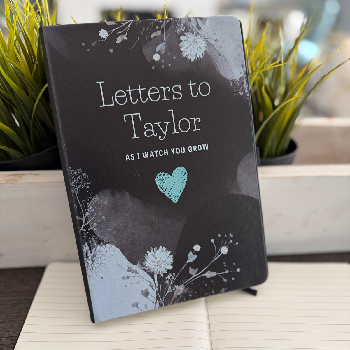 Book titled 'Letters to Baby As I Watch You Grow' with decorative cover on a surface. Perfect for a Baby Shower gift. 