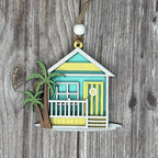 Decorative ornament of a beach house with a palm tree on a wooden background