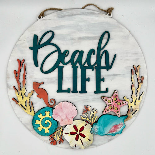 Decorative sign with 'Beach Life' text and beach-themed elements on a white background