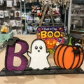 A decorative shelf sitter featuring a 'BOO' letter with a ghost and a pumpkin design, intended for a mini maker project.