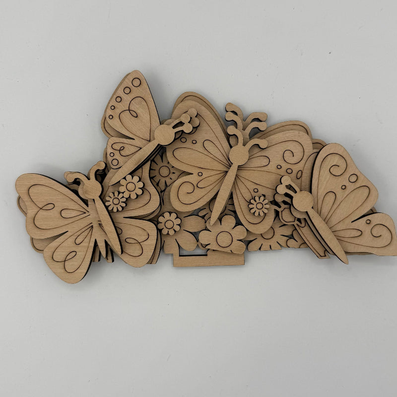 Wooden butterfly and flower cutouts on a white background