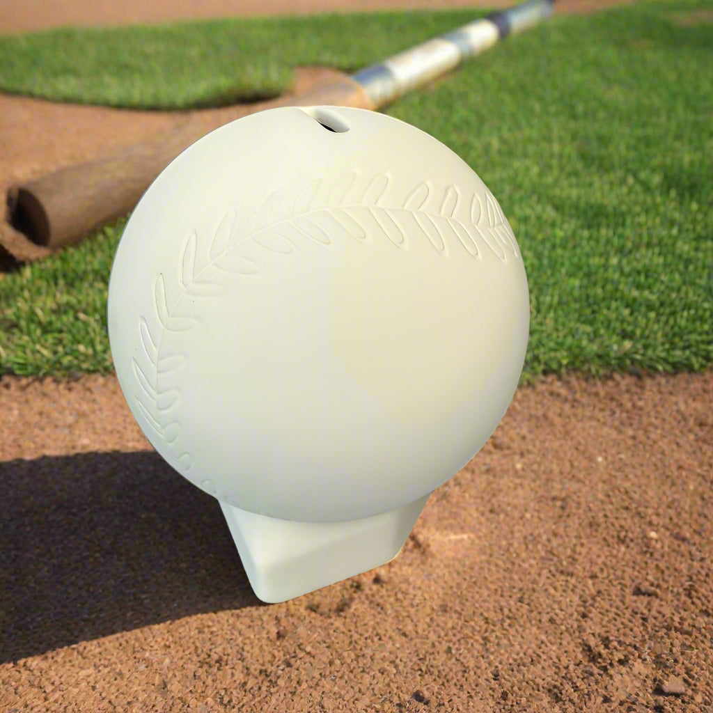 White ceramic ball with embossed design on a wooden surface