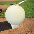 White ceramic ball with embossed design on a wooden surface