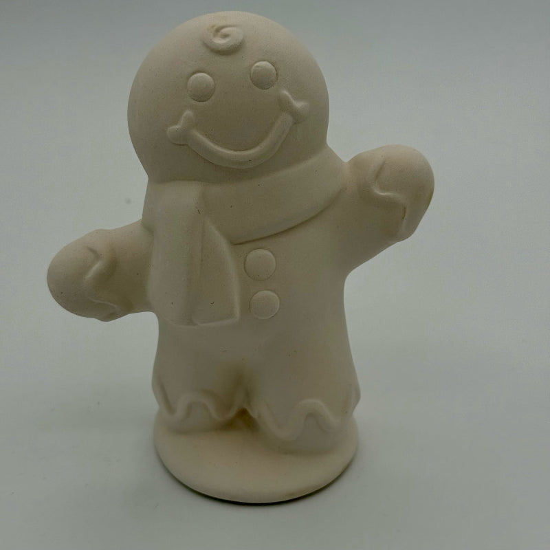 Unpainted gingerbread man figurine on a white background
